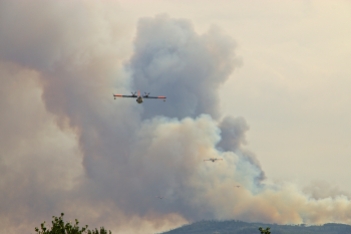 Cropped telephoto shot makes the fire look closer than it was. This image shows all four water bombers in service.